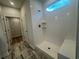 Bright bathroom with a glass-enclosed shower, white subway tiles, and a view from the large window at 1209 Lady Bird Way, North Myrtle Beach, SC 29582