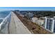 A long sandy beach and ocean views from the coast with hotels and trees along the shoreline at 1209 Lady Bird Way, North Myrtle Beach, SC 29582