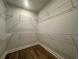 Walk-in closet with wire shelving and hardwood floors at 1209 Lady Bird Way, North Myrtle Beach, SC 29582