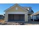 A spacious two-car garage with plenty of room for parking and storage in a new construction yellow home at 1209 Lady Bird Way, North Myrtle Beach, SC 29582