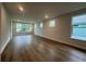 Spacious living room featuring hardwood floors, recessed lights, and large windows offering a view of outside at 1209 Lady Bird Way, North Myrtle Beach, SC 29582