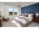 Beautiful main bedroom featuring a king bed, accent wall, and large windows that overlook the outdoors at 1209 Lady Bird Way, North Myrtle Beach, SC 29582