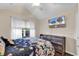 Bright bedroom with vaulted ceiling, television, modern dresser, and a view of trees outside the window at 145 Stonegate Blvd. # 145, Murrells Inlet, SC 29576