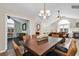 Open dining room features wooden table, woven chairs, and seamless flow to multiple living spaces at 145 Stonegate Blvd. # 145, Murrells Inlet, SC 29576