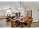 Dining room overlooking the living room featuring wooden table, woven chairs, and chandelier at 145 Stonegate Blvd. # 145, Murrells Inlet, SC 29576