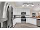 Well-equipped kitchen with white cabinetry, stainless appliances, and modern lighting at 145 Stonegate Blvd. # 145, Murrells Inlet, SC 29576