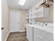 Clean laundry room with washer, dryer, shelving, and tile flooring at 145 Stonegate Blvd. # 145, Murrells Inlet, SC 29576