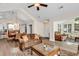 Open-concept living room boasts high ceilings, wood floors, and seamless flow to dining and lounge areas at 145 Stonegate Blvd. # 145, Murrells Inlet, SC 29576