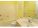 Clean bathroom featuring a vanity with sink, toilet, and bathtub-shower combo with yellow walls at 1512 Hallborough Dr., Surfside Beach, SC 29575