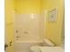 Bright yellow bathroom with a standard white shower and toilet at 1512 Hallborough Dr., Surfside Beach, SC 29575