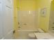 Bright bathroom with a shower-tub combo and yellow walls at 1512 Hallborough Dr., Surfside Beach, SC 29575