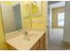 Well-lit bathroom showcasing a sink vanity, mirror, and open doorway to a carpeted room at 1512 Hallborough Dr., Surfside Beach, SC 29575