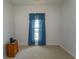 Bedroom featuring plush carpeting, neutral walls, and a window adorned with blue curtains at 1512 Hallborough Dr., Surfside Beach, SC 29575