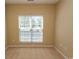 Bright bedroom featuring neutral carpet, yellow walls, and a window with white blinds at 1512 Hallborough Dr., Surfside Beach, SC 29575