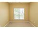 An empty bedroom with carpet flooring and a window providing natural light at 1512 Hallborough Dr., Surfside Beach, SC 29575