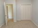 Well-lit bedroom features neutral carpet, closet and light gray walls at 1512 Hallborough Dr., Surfside Beach, SC 29575