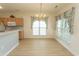 Dining area with a view to the kitchen, featuring an elegant chandelier and bright windows at 1512 Hallborough Dr., Surfside Beach, SC 29575