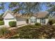 Inviting home exterior with green shutters, manicured lawn, and mature trees providing shade at 1512 Hallborough Dr., Surfside Beach, SC 29575