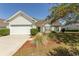 Charming single-story home with white siding, well-maintained landscaping, and an attached two-car garage at 1512 Hallborough Dr., Surfside Beach, SC 29575