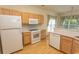 A bright kitchen highlighting stainless steel appliances, light wood cabinetry, and an efficient layout at 1512 Hallborough Dr., Surfside Beach, SC 29575