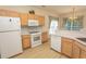 Kitchen with appliances, countertops, wood cabinets and bright, open floor plan at 1512 Hallborough Dr., Surfside Beach, SC 29575
