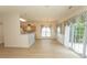 Bright living area featuring wood-look flooring, updated windows, and a breakfast bar to the kitchen at 1512 Hallborough Dr., Surfside Beach, SC 29575