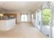 Open-concept living space with a view into the kitchen area, complemented by light-filled windows and a sliding glass door at 1512 Hallborough Dr., Surfside Beach, SC 29575