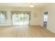 Open-concept living room showcasing hardwood flooring and sliding doors to the backyard for natural light at 1512 Hallborough Dr., Surfside Beach, SC 29575