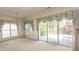 Bright living room with large windows, floral valances, and sliding glass doors leading to the backyard at 1512 Hallborough Dr., Surfside Beach, SC 29575