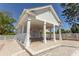 Community pool house with white pillars and an outdoor entertainment area by a pool at 1512 Hallborough Dr., Surfside Beach, SC 29575