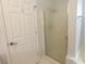 Bathroom featuring a glass-enclosed shower with white trim, adjacent to a white door at 1512 Hallborough Dr., Surfside Beach, SC 29575