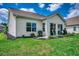 Spacious backyard with well-manicured landscaping, patio, and vibrant green grass at 168 Zostera Dr., Little River, SC 29566