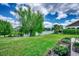 Lush backyard with a pond view, mature trees, and manicured lawn at 168 Zostera Dr., Little River, SC 29566