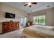 Bright bedroom with dresser, desk, and a door leading to the outside at 168 Zostera Dr., Little River, SC 29566