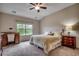 Cozy bedroom featuring a plush bed, wood furniture, and a sunlit window view at 168 Zostera Dr., Little River, SC 29566