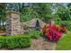 Attractive stone community sign surrounded by lush greenery and bright flowers at 168 Zostera Dr., Little River, SC 29566