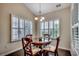 Bright breakfast nook with a round dining table with seating for four and plantation shutters at 168 Zostera Dr., Little River, SC 29566