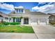 Charming home featuring a two-car garage, manicured lawn, and inviting front porch at 168 Zostera Dr., Little River, SC 29566