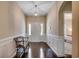 Welcoming foyer with dark wood floors, wainscoting and a decorative light fixture at 168 Zostera Dr., Little River, SC 29566