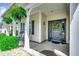 Inviting front porch with ferns and black rocking chairs with a decorative door wreath at 168 Zostera Dr., Little River, SC 29566