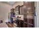 Close up of the Kitchen showing stainless appliances, tile backsplash, and dark wood cabinets at 168 Zostera Dr., Little River, SC 29566