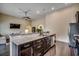 Kitchen with a granite-topped breakfast bar and island, dark wood cabinets and stainless appliances at 168 Zostera Dr., Little River, SC 29566