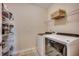 Convenient laundry room with modern washer and dryer, wire shelving, and ample storage space at 168 Zostera Dr., Little River, SC 29566