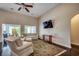 Spacious living room with dark hardwood floors, high ceilings, and a wall-mounted TV at 168 Zostera Dr., Little River, SC 29566
