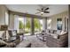 Inviting sunroom overlooking a tranquil lake with floor-to-ceiling windows at 168 Zostera Dr., Little River, SC 29566