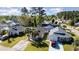 A high angle aerial shot of the house in a community featuring mature trees, manicured lawns, and paved driveways at 174 Sussex Ct., Longs, SC 29568