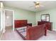 Cozy bedroom featuring a ceiling fan, dresser with mirror, carpet, and adjacent bathroom with shower at 174 Sussex Ct., Longs, SC 29568