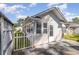 White home exterior featuring a gated patio with a sunny backyard and pristine landscaping at 174 Sussex Ct., Longs, SC 29568