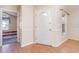 Bright foyer with light walls, wood-look floors, and a view into a bedroom through an open doorway at 174 Sussex Ct., Longs, SC 29568