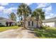Charming single story home with brick accents and driveway, framed by two majestic palm trees on a well-manicured lawn at 174 Sussex Ct., Longs, SC 29568